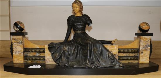 An Art Deco spelter and marble girl on a a bench